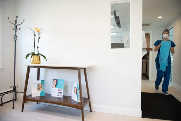 Lobby console table with brochures as a team member walks by