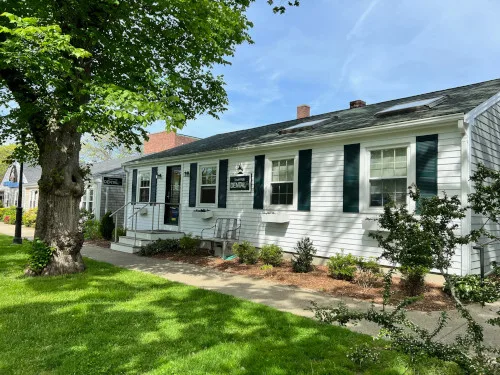 Town Hall Dental Spa office exterior, a white single-story building with dark shutters and a lawn
