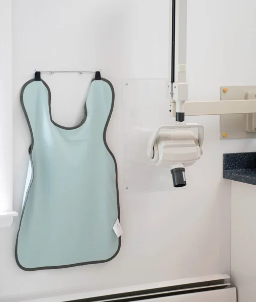 Lead x-ray apron hanging next to the digital x-ray unit